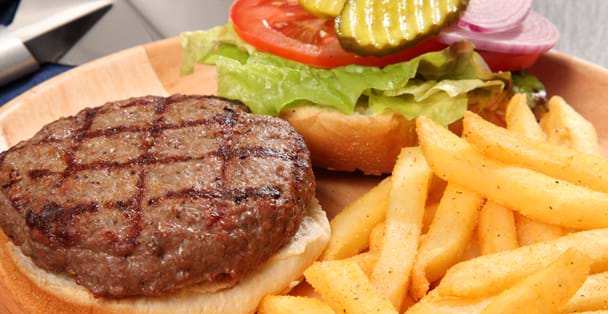 A plate with a harmburger and french fries.
