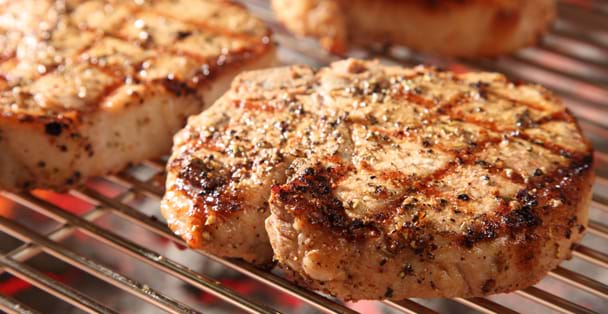 Close up of a bonelesspork chop on a grill.
