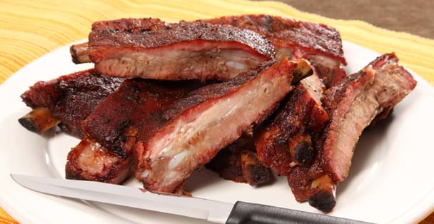 Plate of ribs with the black handled utility/steak